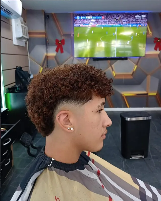 Curly fade haircut with a clean lineup