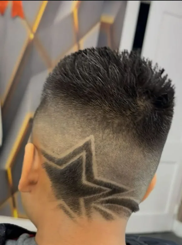 Fade haircut with a star design shaved into the side
