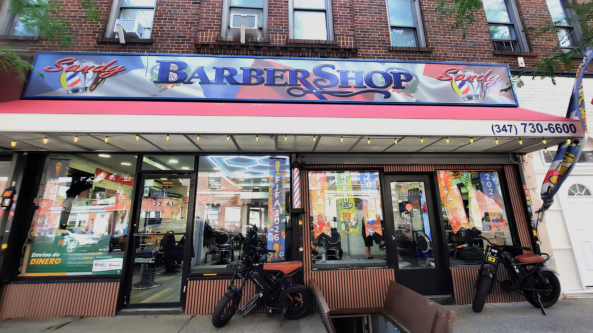 Full Sandy Barber Shop storefront on 80th Street
