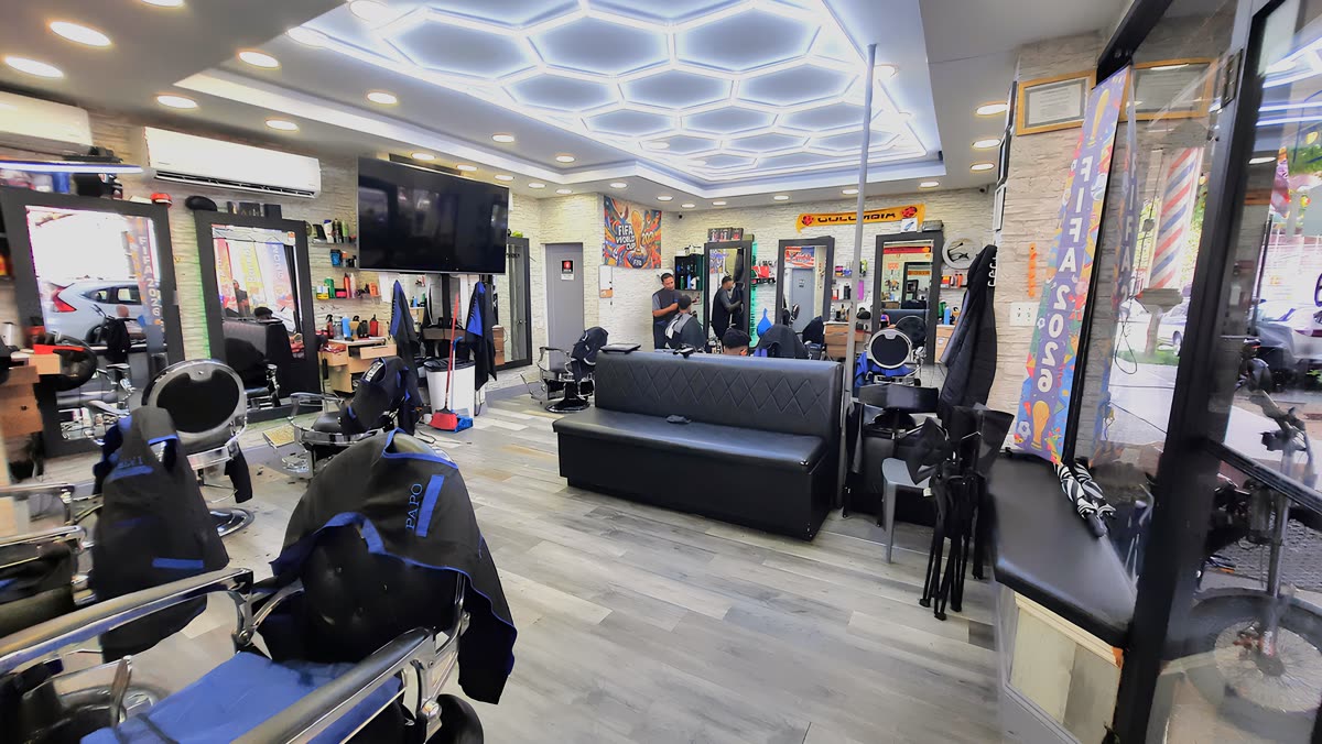 Inside Sandy Barber Shop with barber chairs and mirrors